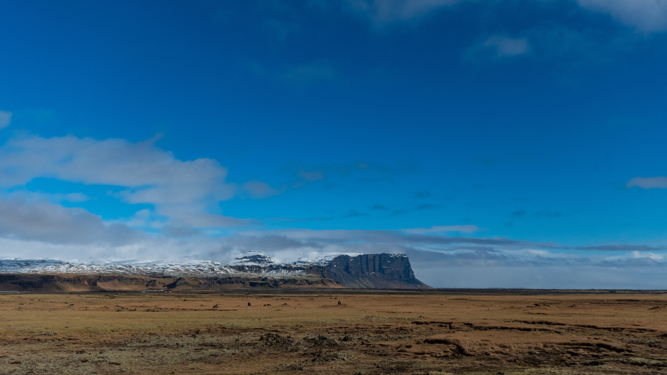 Blue sky and low-level cloud over Kálfafell, Iceland