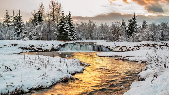 Elliðaárdalur Valley in the snow at sunset.