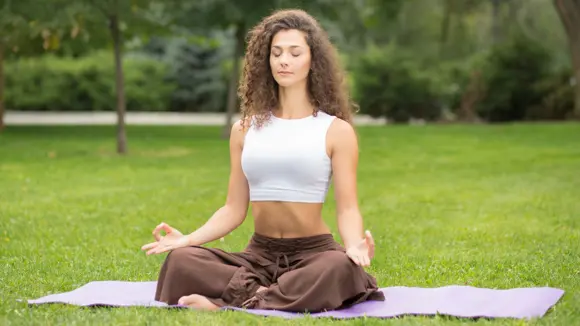 Woman practising yoga in the park.
